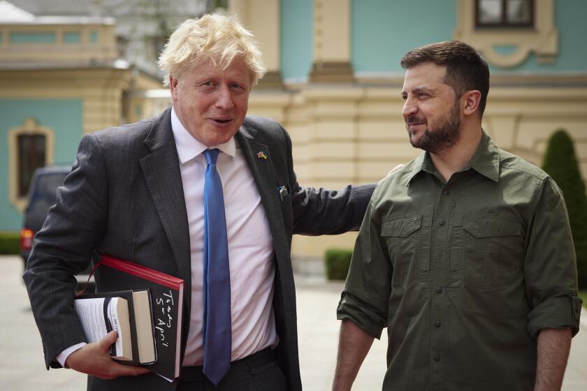 In this image provided by the Ukrainian Presidential Press Office, Ukrainian President Volodymyr Zelenskyy, right, and Britain's Prime Minister Boris Johnson, ahead of their meeting in Kyiv, Ukraine, Friday, June 17, 2022. (Ukrainian Presidential Press Office via AP)