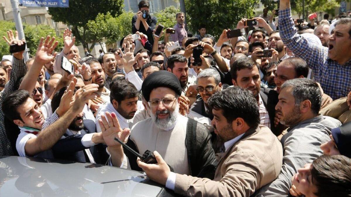 Ebrahim Raisi greets supporters after casting his ballot in the May 19 Iranian presidential election. Raisi finished second but raised his public profile. (Atta Kenare / AFP/Getty Images)