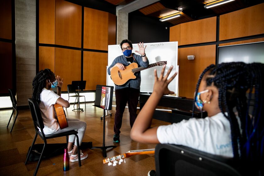SAN DIEGO, CA - JUNE 21: Nico Hueso, a teacher with the San Diego Youth Symphony, teaches students mariachi at Wilson Middle School in the City Heights neighborhood on Monday, June 21, 2021 in San Diego, CA. The class is part of "Level Up SD," a partnership between the San Diego Unified School District and The San Diego Foundation that provides in-person learning and summer enrichment activities to local students throughout the summer. (Sam Hodgson / The San Diego Union-Tribune)