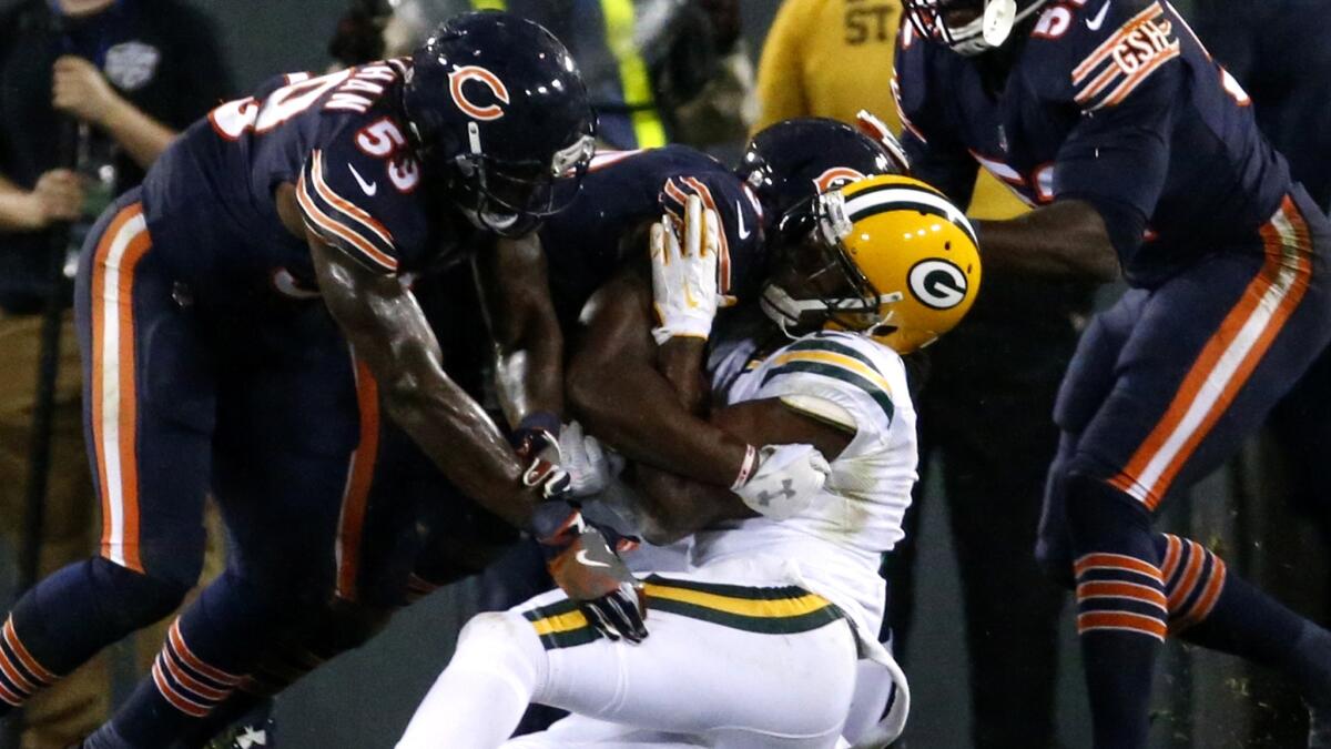 Packers' receiver Davante Adams goes down after being hit in the head by Bears linebacker Danny Trevathan (59) during Thursday night's game.