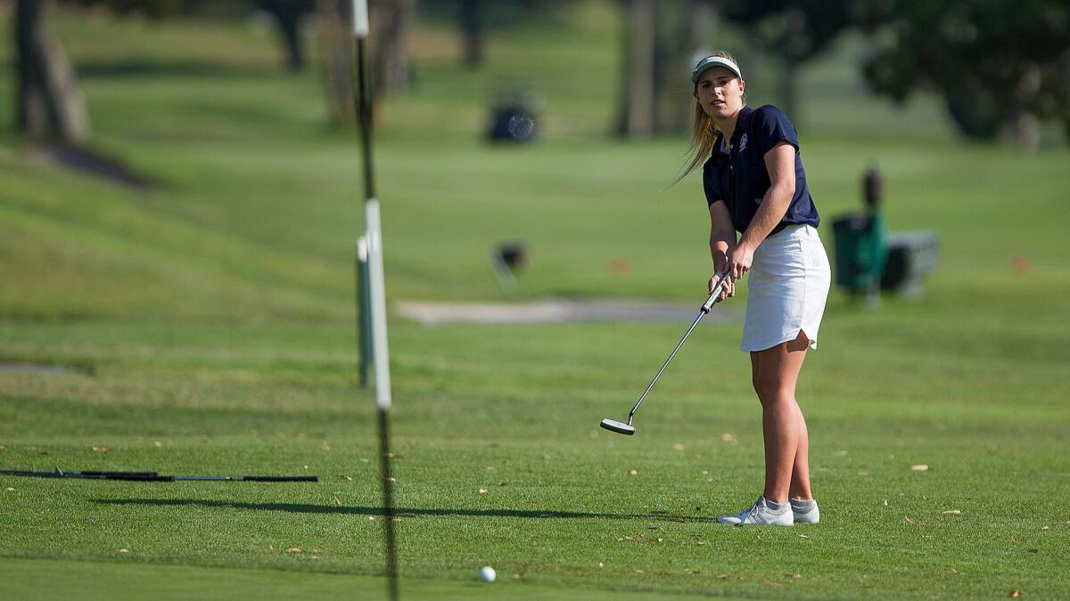Newport Harbor's Nicole Nesbitt putts on to the green during the Battle of the Bay girls' golf match against Corona del Mar at the Newport Beach Country Club on Thursday. Nesbitt was the low-medalist with a round of 40, helping the Sailors to a 234-242 victory.