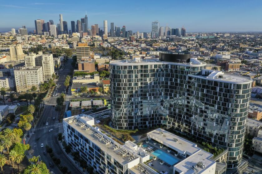 Los Angeles, CA - October 20: An exterior view of the $300 million Kurve on Wilshire in Koreatown on Wednesday, Oct. 20, 2021. The $300 million Kurve on Wilshire sports an elevated outdoor deck larger than many public parks. Luxurious apartment buildings have a long history in Los Angeles and the appetite for deluxe living quarters has been unabated the pandemic. Among the new arrivals is the Kurve on Wilshire which features upscale amenities such as the one-acre rooftop park and pool, outdoor movie theater, sports lounge and Korean barbecues. (Allen J. Schaben / Los Angeles Times)