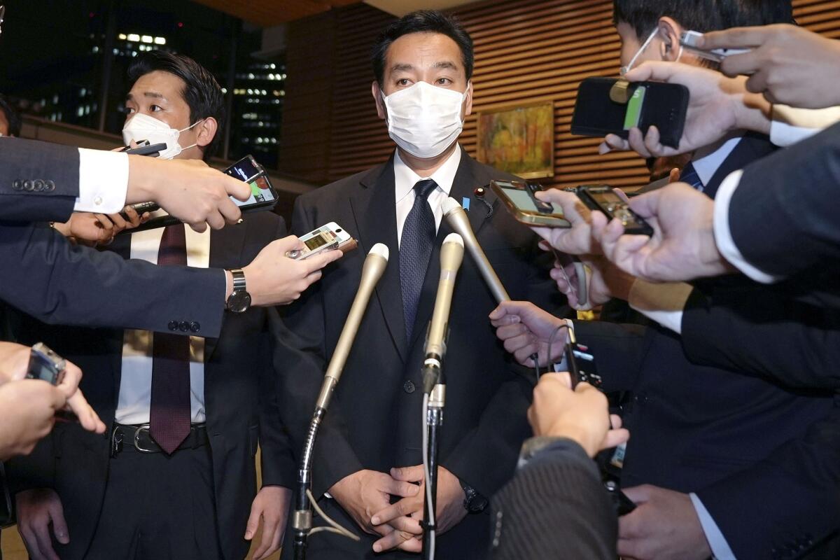 Japanese Economy Minister Daishiro Yamagiwa surrounded by reporters