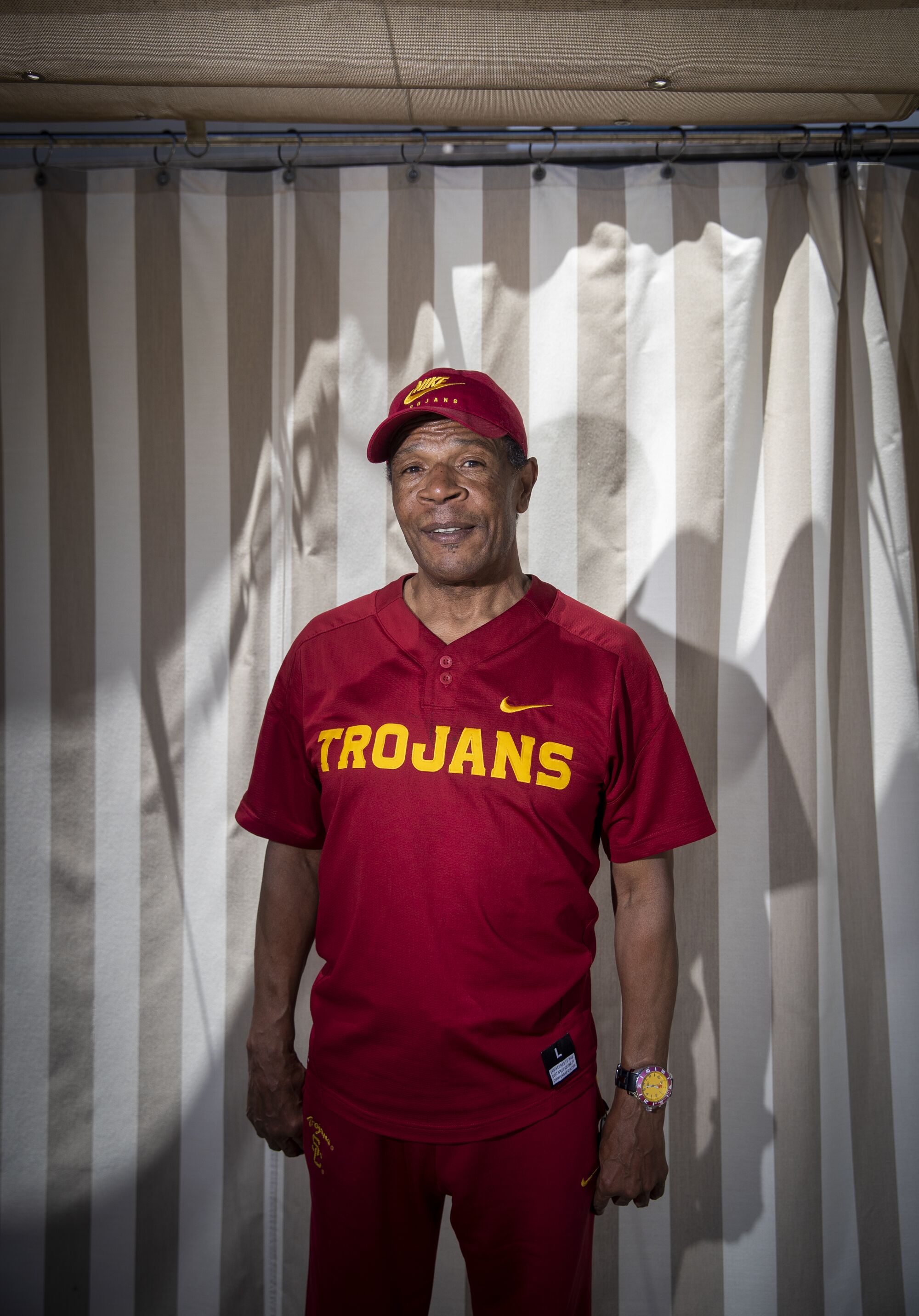 Charles White stands in front of a wall.