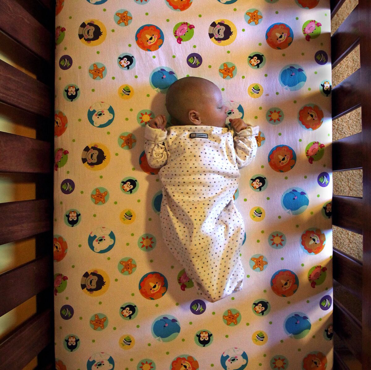 A baby sleeping in a crib. 