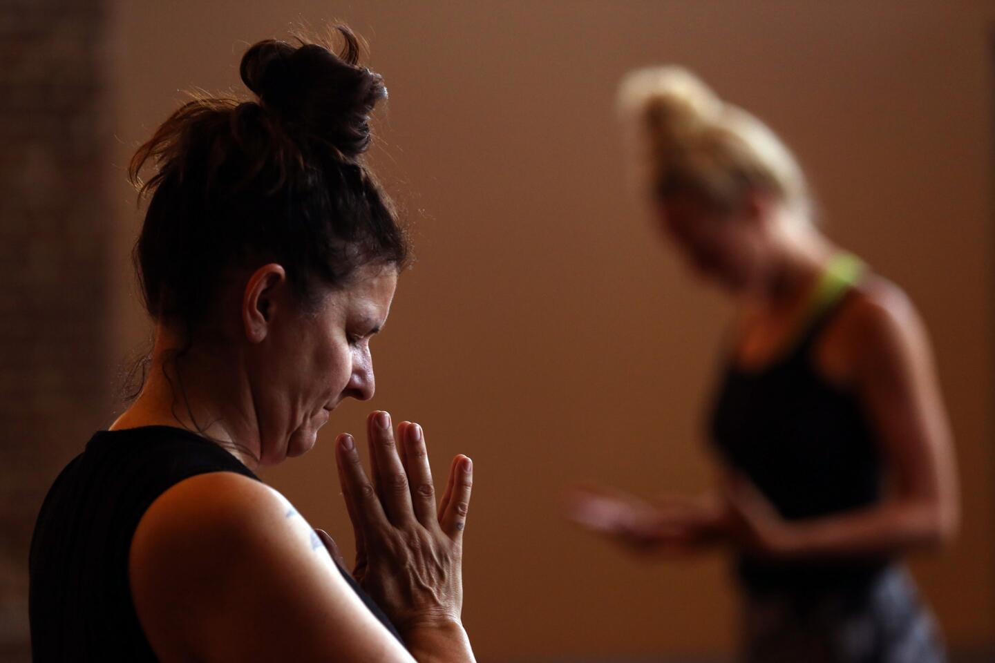 The Flow yoga class is taught by Jenn Perry, right, at Wanderlust Hollywood, a meditation and yoga center. The Hollywood studio is a fusion of classes and experiences, including yoga, nutrition, meditation, film screenings, wine tastings and jewelry making.