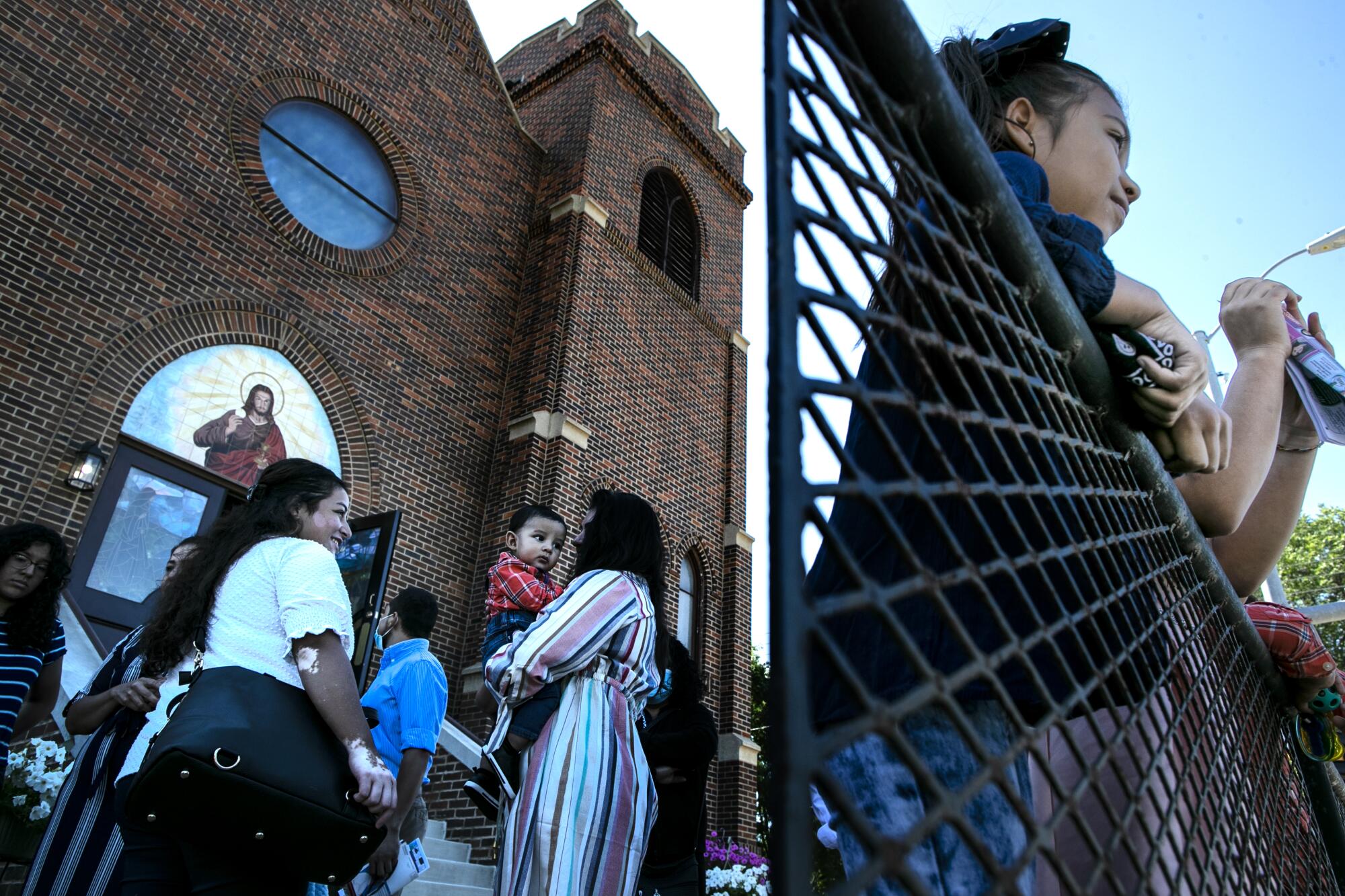 Parishioners gather after Mass at Our Lady of Guadalupe Catholic Church.