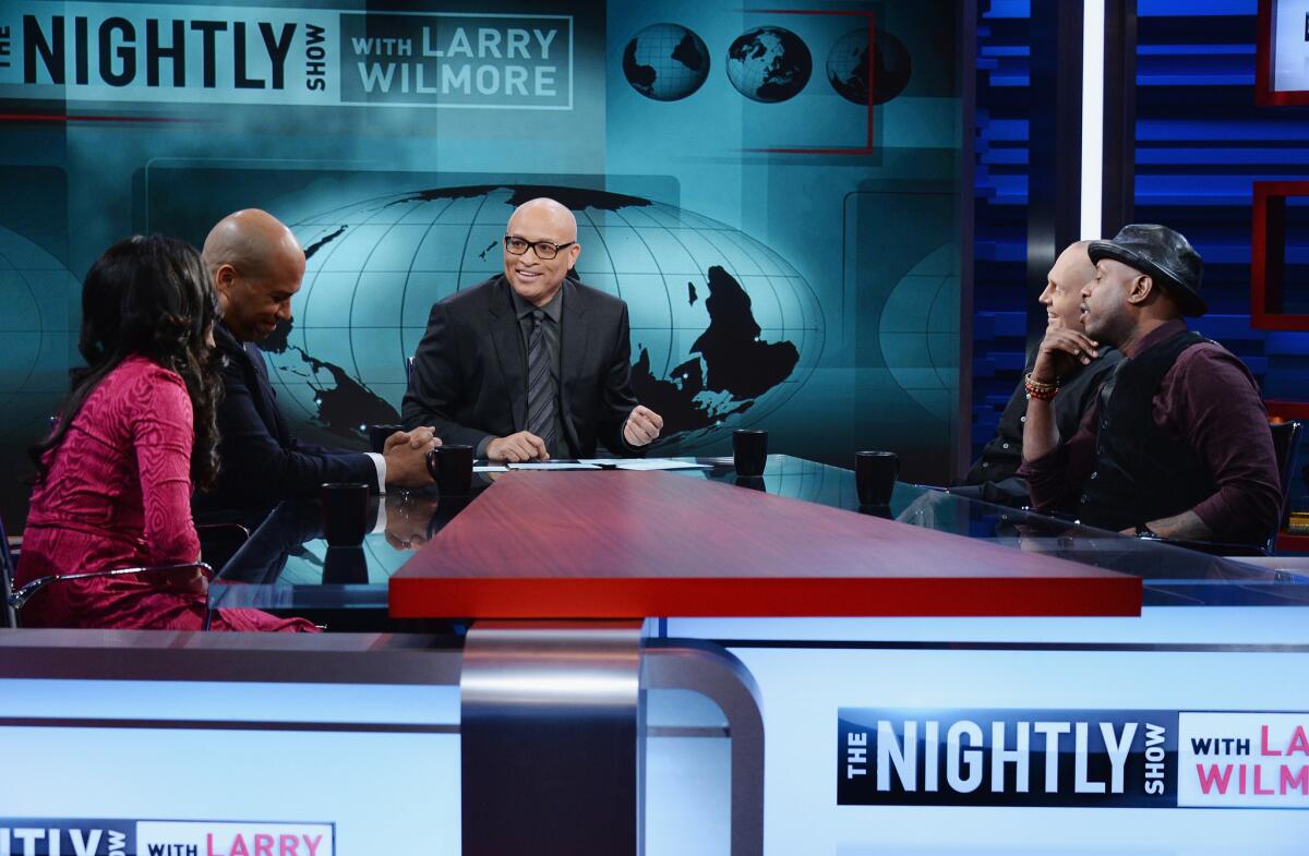 From left, Shenaz Treasury, Sen. Cory Booker (D-N.J.), host Larry Wilmore, Bill Burr and Talib Kweli appear in the first episode of "The Nightly Show" on Monday.
