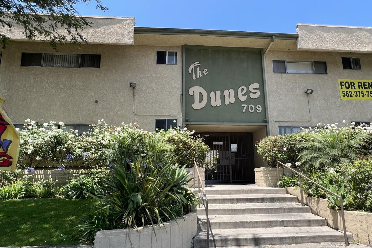 An apartment building bears the words "The Dunes" above its entrance.