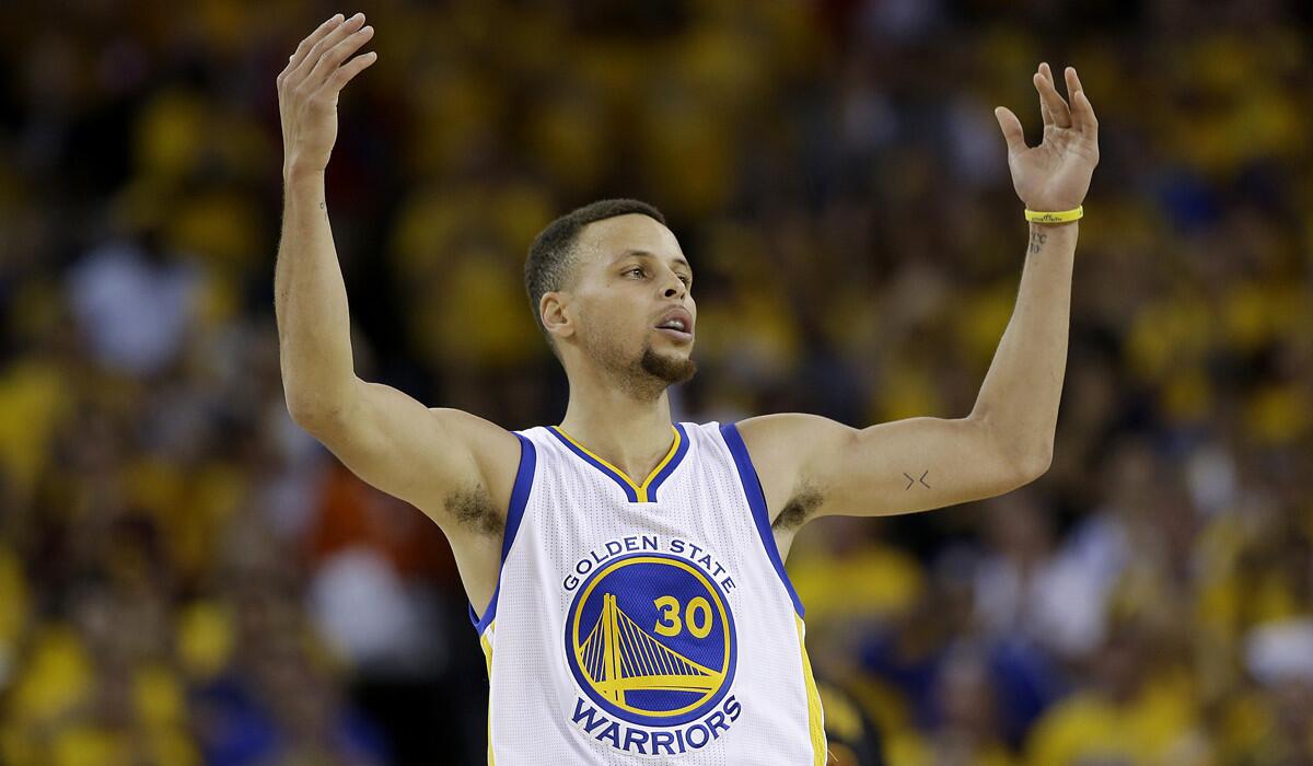 Golden State Warriors guard Stephen Curry gestures after scoring against the Cleveland Cavaliers during the second half of Game 7 of the NBA Finals.