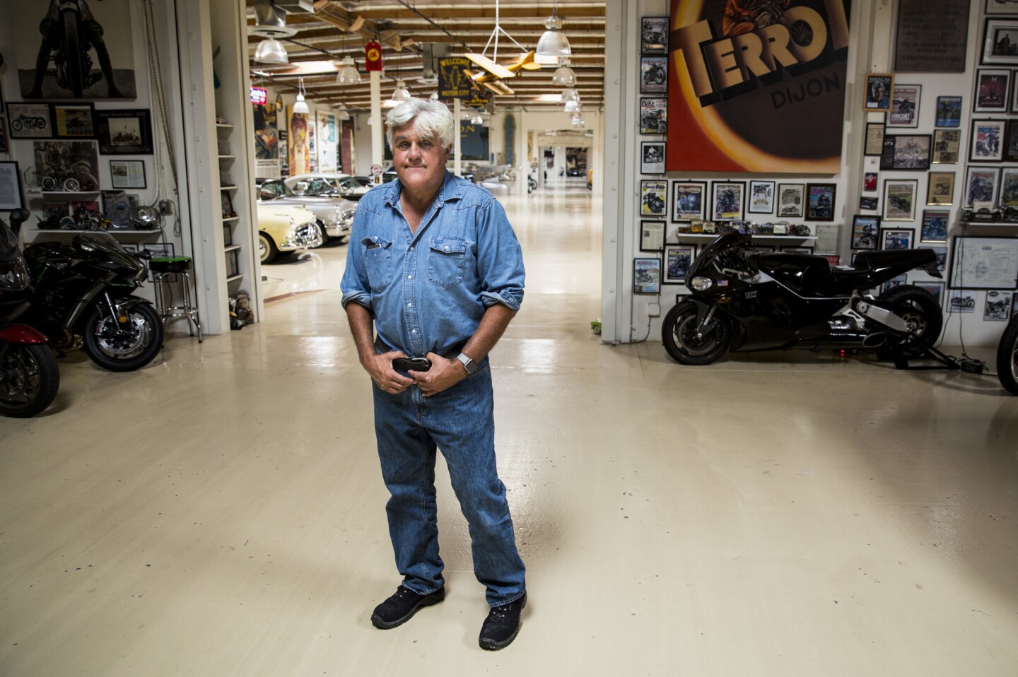 Comedian and car aficionado Jay Leno pauses inside his Big Dog Garage, which houses an extensive, collection of historical cars and motorcycles, in Burbank, Calif.