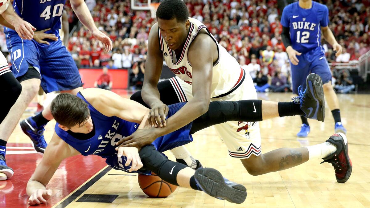 Duke's Grayson Allen, bottom, and Louisville's Jaylen Johnson get tangled while battling for a loose ball during the second half of their game Saturday.