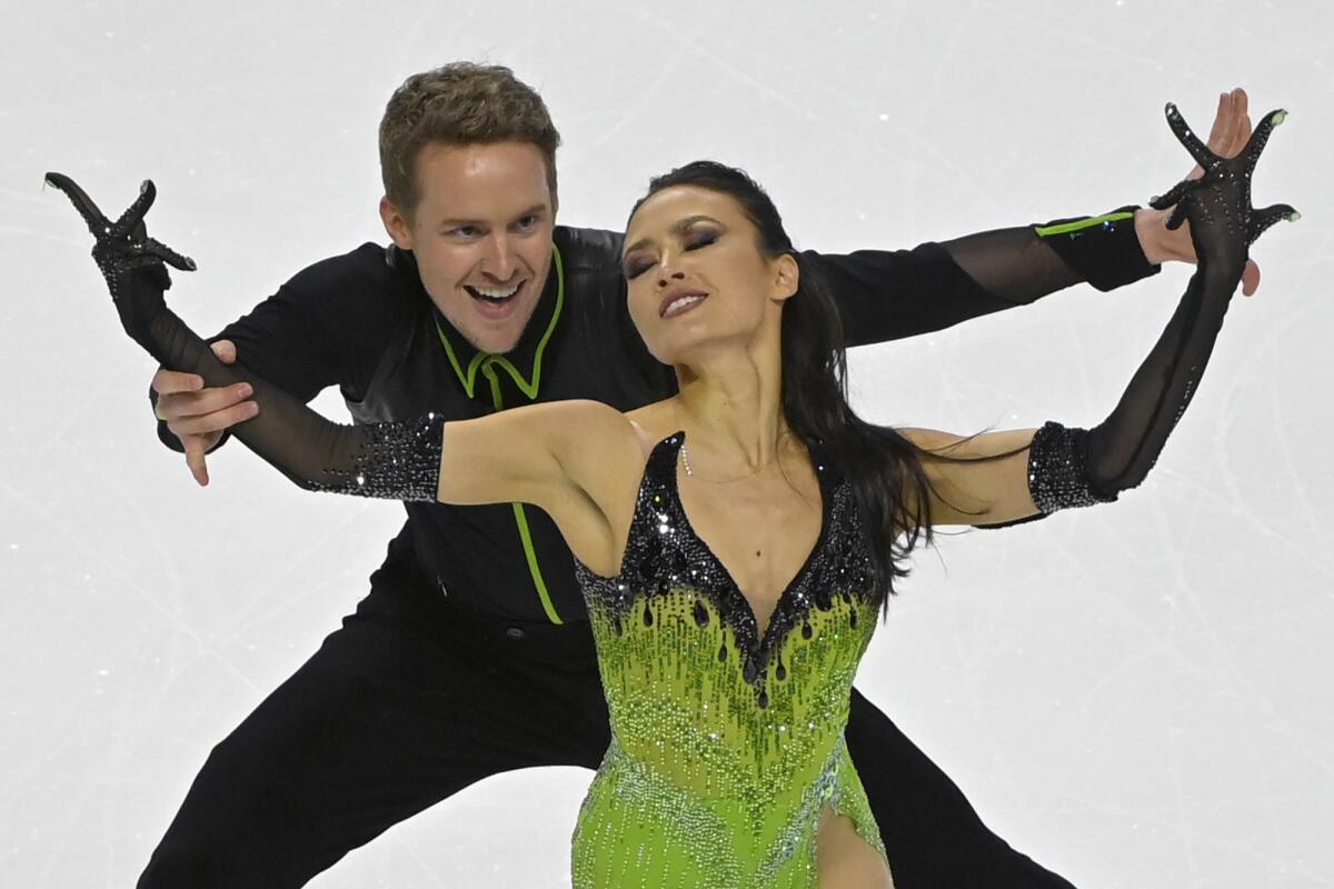 Skaters Madison Chock and Evan Bates perform on the ice.