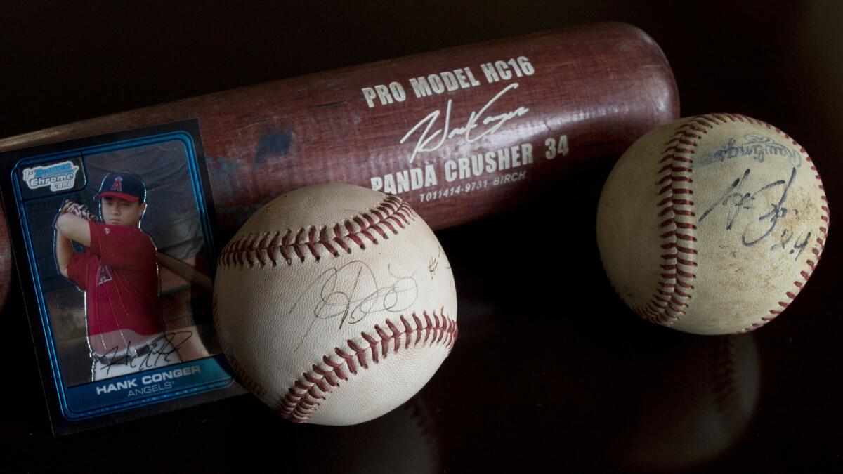 Anaheim Angels catcher Hank Conger's signature has evolved at least a couple times since his childhood playing days. The ball autographs from his early playing days differ from his current autograph, which is etched on the bat.