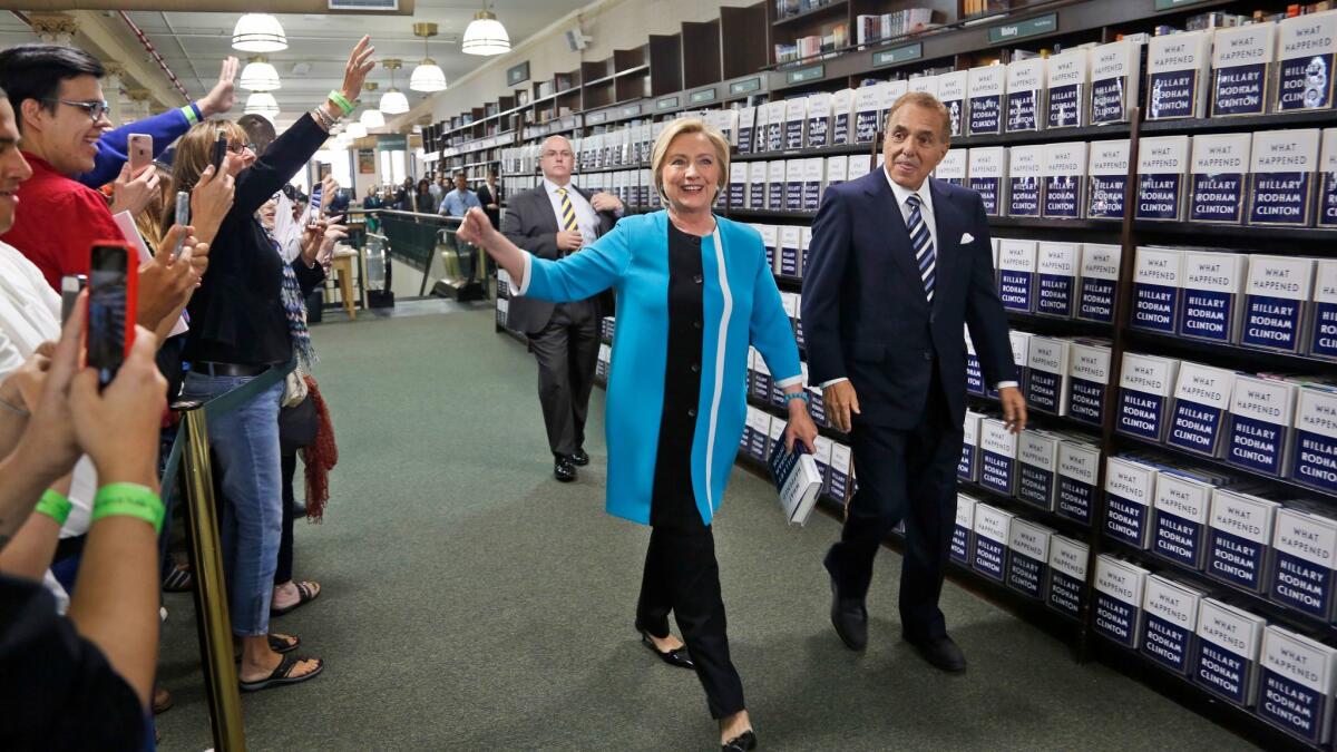 Hillary Clinton, with Leonard Riggio, chairman of the Barnes & Noble bookstore chain, arrives to sign copies of her book "What Happened" in New York City.