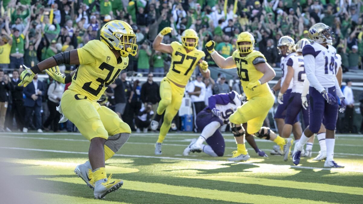 Oregon running back CJ Verdell (34), scores the winning touchdown in overtime to beat Washington 30-27 on Saturday.