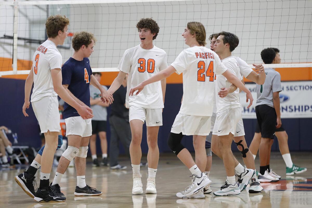 Pacifica Christian's Knox Vail (30) celebrates a big block with teammates during a nonleague match against Sage Hill.