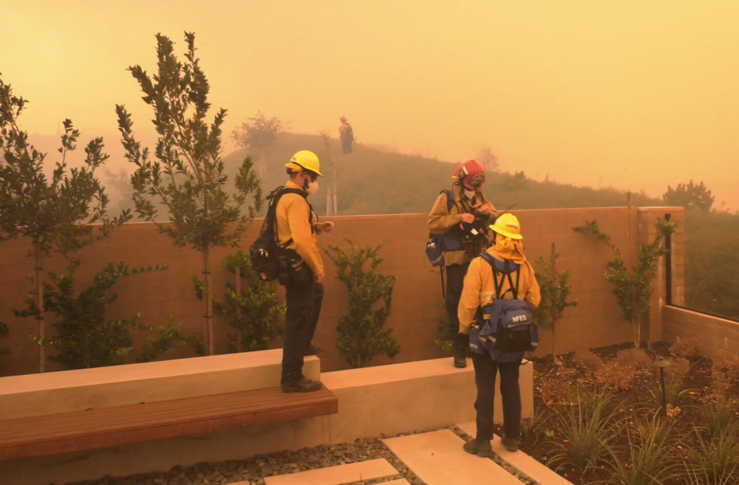 Orange County Fire Authority firefighters monitor the Silverado fire, which is threatening communities in Irvine