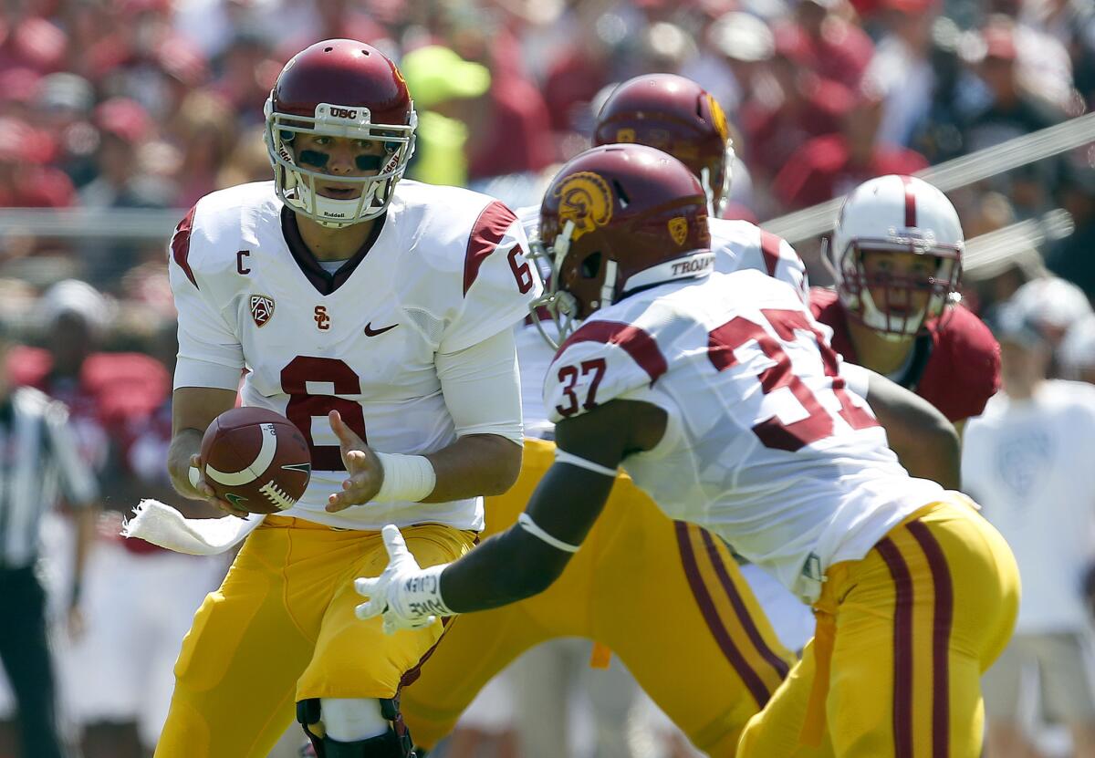 USC quarterback Cody Kessler hands off to running back Javorius Allen against Stanford. The pair of junior might play their final game for the Trojans in the Holiday Bowl on Dec. 27.