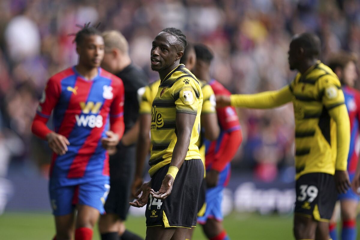 Watford's Hassane Kamara reacts to being shown a red card, during the Premier League match between Crystal Palace and Watford at Selhurst Park, London, Saturday May 7, 2022. (Yui Mok/PA via AP)