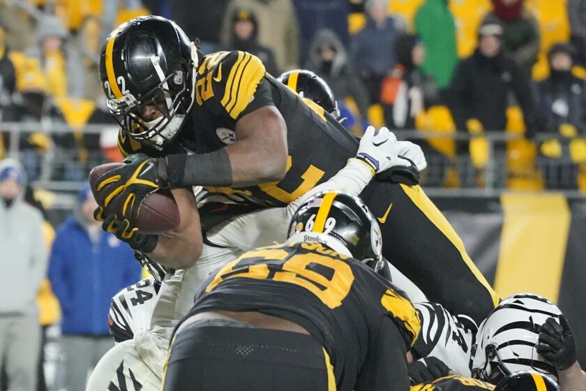 Pittsburgh Steelers running back Najee Harris (22) goes over the top to score a touchdown against the Cincinnati Bengals during the second half of an NFL football game, Sunday, Nov. 20, 2022, in Pittsburgh. The Bengals won 37-30. (AP Photo/Gene J. Puskar)