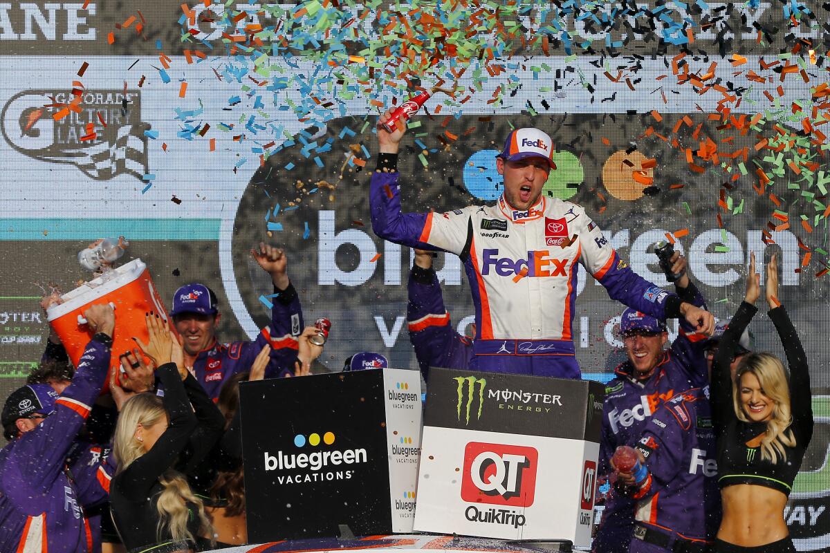 Denny Hamlin celebrates after winning Sunday's NASCAR Cup race at ISM Raceway.