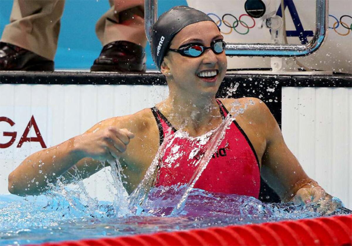 U.S. swimmer Rebecca Soni celebrates with a splash after winning the women's 200-meter breaststroke, setting a world record at 2:19:59 at the 2012 London Olympics.
