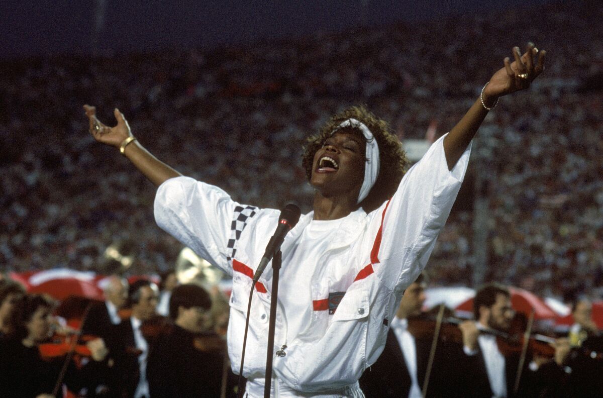 Whitney Houston sings the national anthem before a game between the New York Giants and the Buffalo Bills prior to Super Bowl XXV at Tampa Stadium on Jan. 27, 1991.