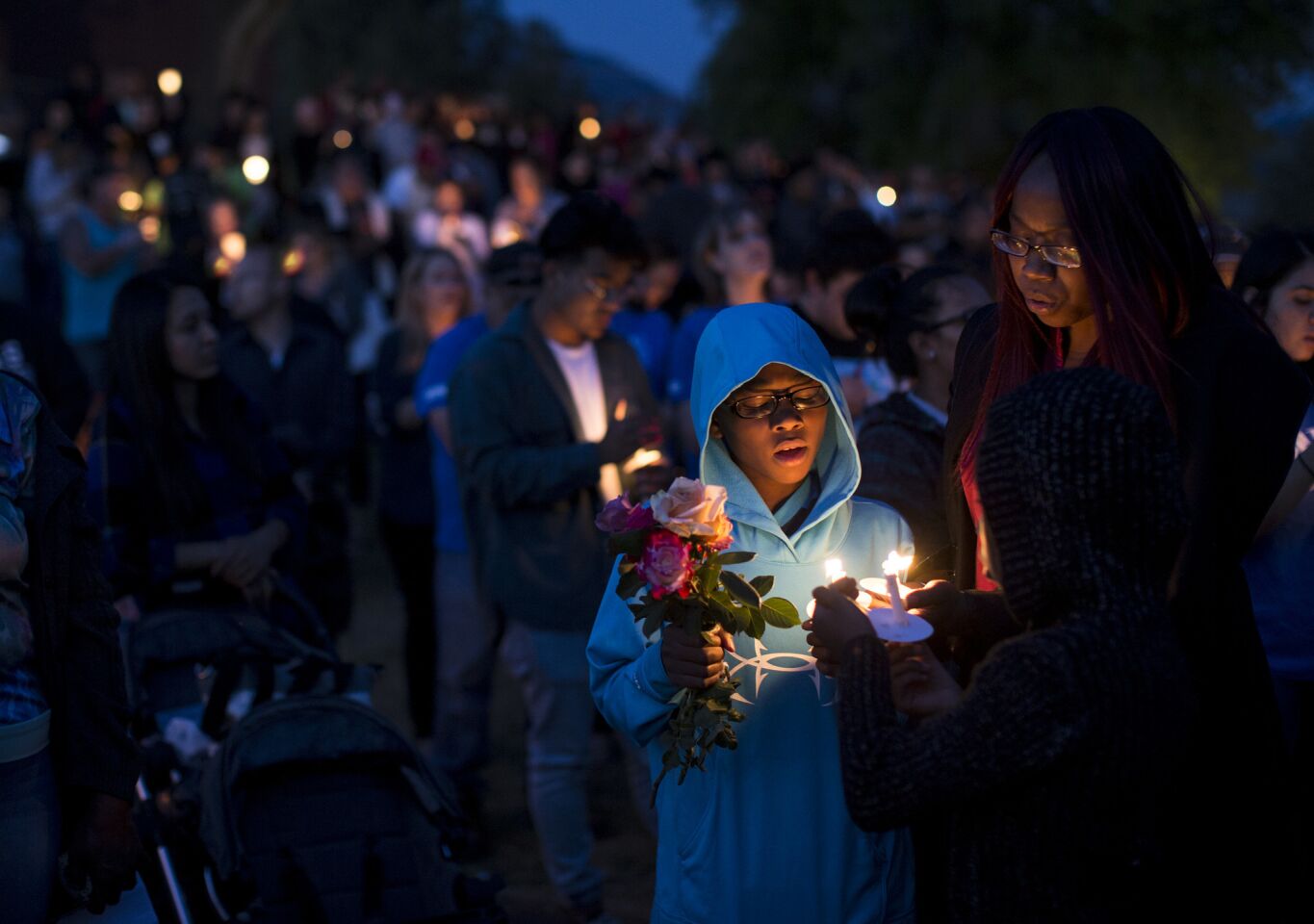 North Park student Elijah Beaven attends a candlelight prayer vigil with his mother, Laura Beaven.