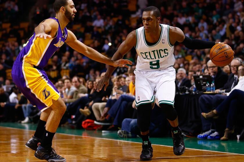 Celtics point guard Rajon Rondo, right, sets up the offense against Lakers point guard Kendall Marshall in a Jan. 17 game in Boston, a Lakers win. It was Rondo's first game back after sitting out nearly a year with a knee injury.