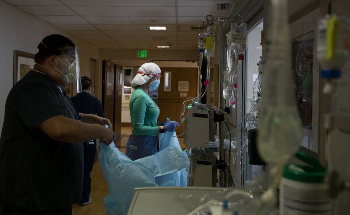 Nurse Joan Pung dons her isolation gowns on Christmas Day at Providence St. Jude Medical Center in Fullerton.
