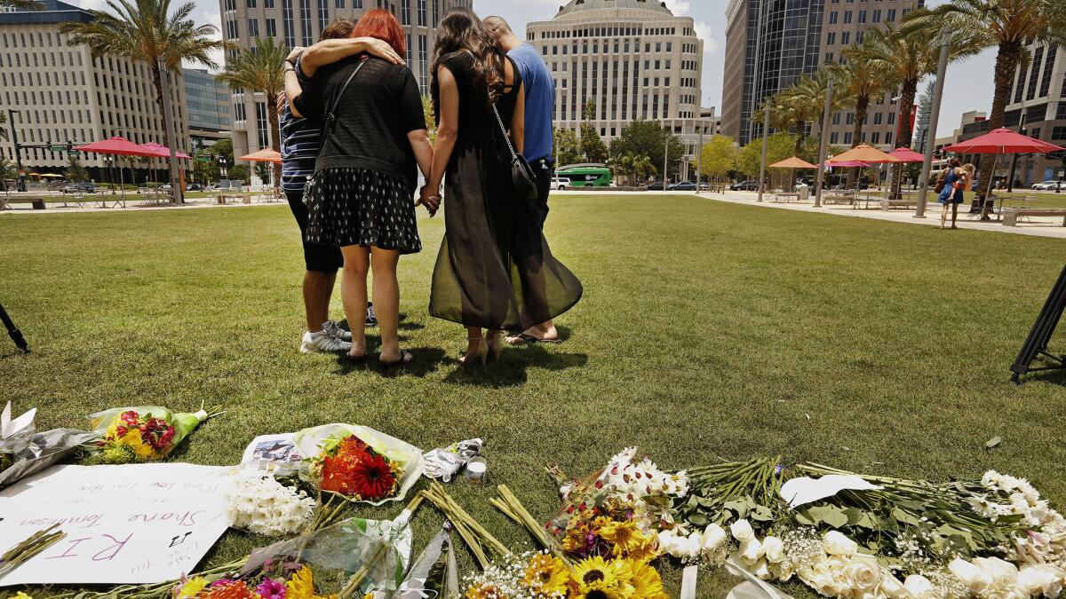 Friends of Shane Tomlinson, who was killed in the Pulse nightclub shooting, gather in prayer and remembrances in downtown Orlando on Monday.