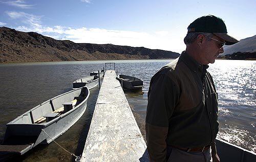 Dick Dotts, president of the Little Lake Ranch hunting club, on the group's dock on Little Lake. The private club is battling a geothermal plant for control of an aquifer in the Eastern Sierra's Owens Valley.