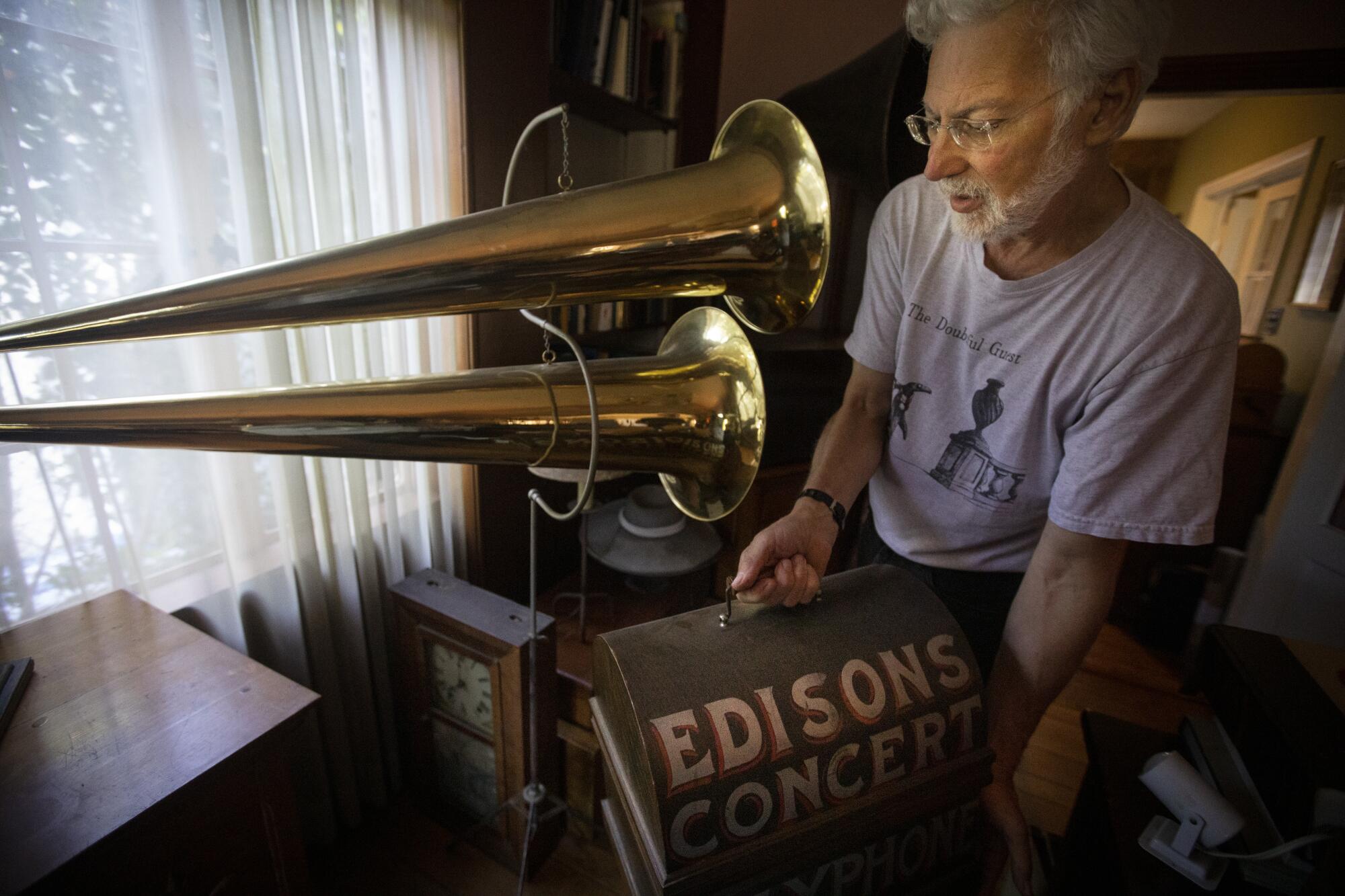 Collector John Levin stands next to what he describes as “a 1900 double-horned phonograph"