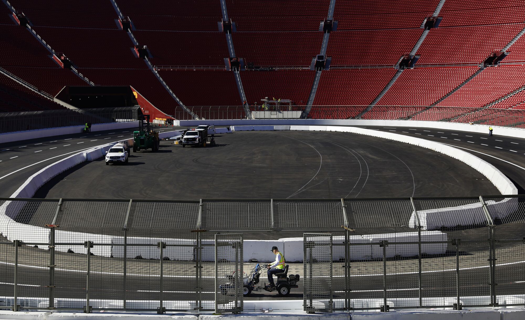 Lane lines are painted ahead of the NASCAR race at the Coliseum.