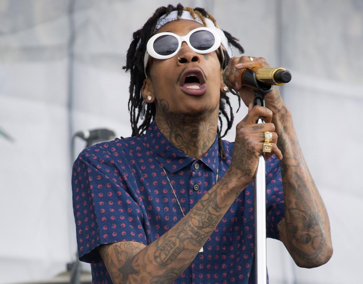 Rapper Wiz Khalifa performs at the Wireless Festival in London on July 5, 2014. Police say a 38-year-old man died Friday after being shot multiple times backstage at Khalifa's concert at a popular Silicon Valley music venue.