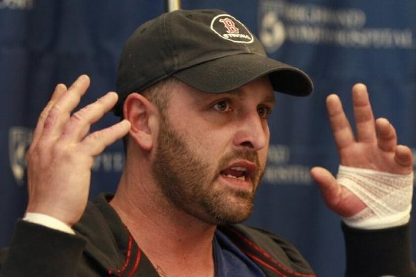Boston Marathon explosion survivor Jarrod Clowery of Stoneham, Mass., describes the bombing scene near the finish line of the race during a news conference at Brigham and Women's Hospital in Boston.