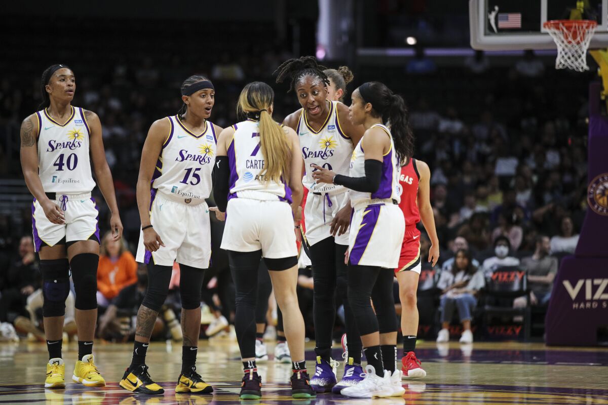 Sparks forward Nneka Ogwumike speaks with teammates during a game.