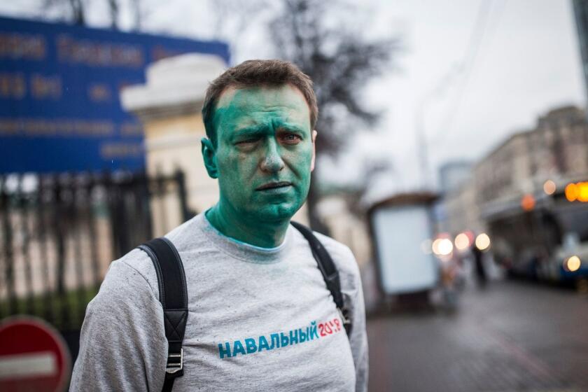In this photo taken on Thursday, April 27, 2017, Russian opposition leader Alexei Navalny poses for a photo after unknown attackers doused him with green antiseptic, outside a conference venue in Moscow, Russia. Navalny, who authored a documentary about the Russian prime minister's alleged corrupt wealth that was viewed more than 20 million times online, was the key force behind nationwide anti-government rallies in March, Russia's largest and most widespread in years. (Evgeny Feldman/Pool Photo via AP)