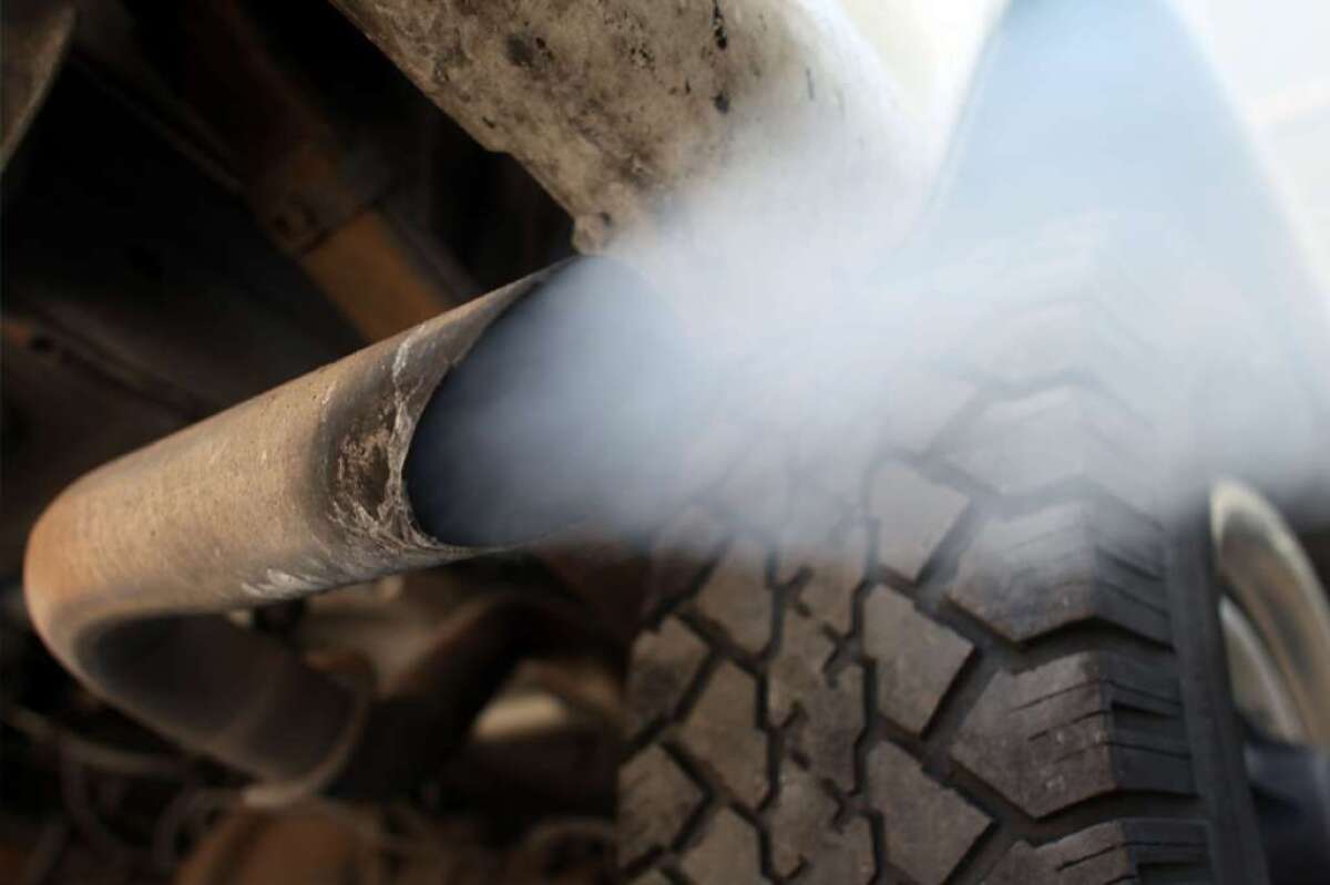 In 2012, fleetwide gas mileage in the U.S. improved 5%. Above, exhaust flows out of a tailpipe in Florida.