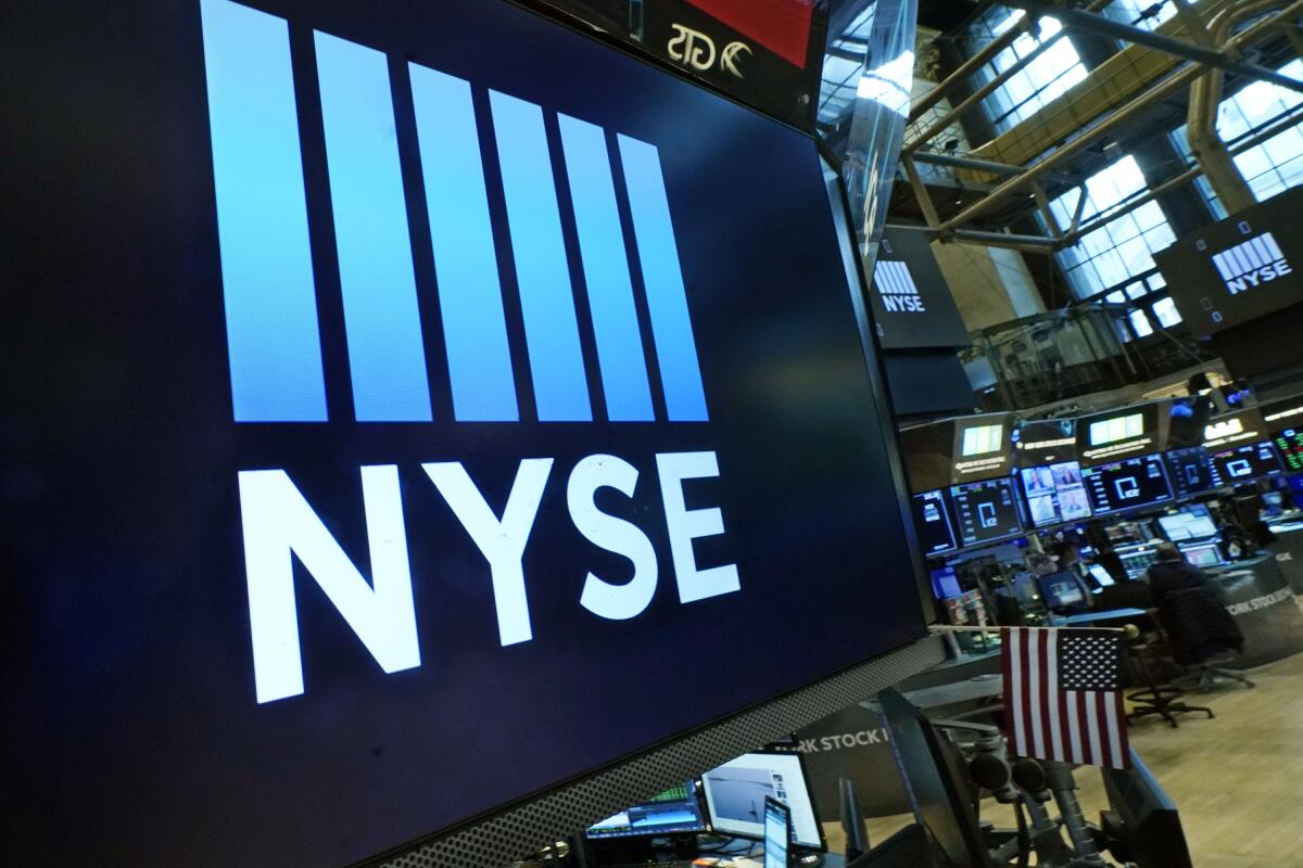 FILE - The New York Stock Exchange logo adorns a trading post on the floor of the Exchange on March 16, 2022, in New York. Stocks are rising again at the start of trading on Wall Street on Friday, Aug. 12, 2022, putting the S&P 500 on track for its first four-week winning streak since November. (AP Photo/Richard Drew, File)