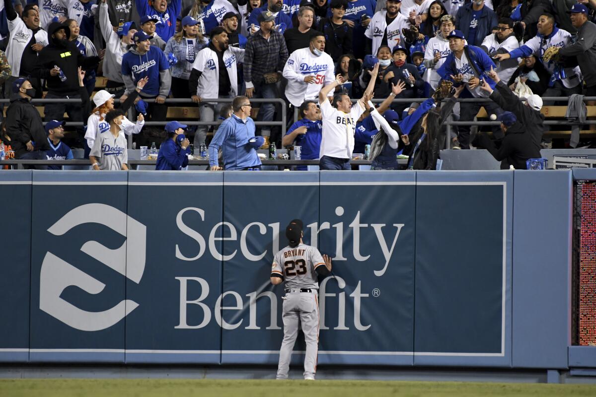 San Francisco Giants right fielder Kris Bryant looks up as fans try to catch a two-run home run.