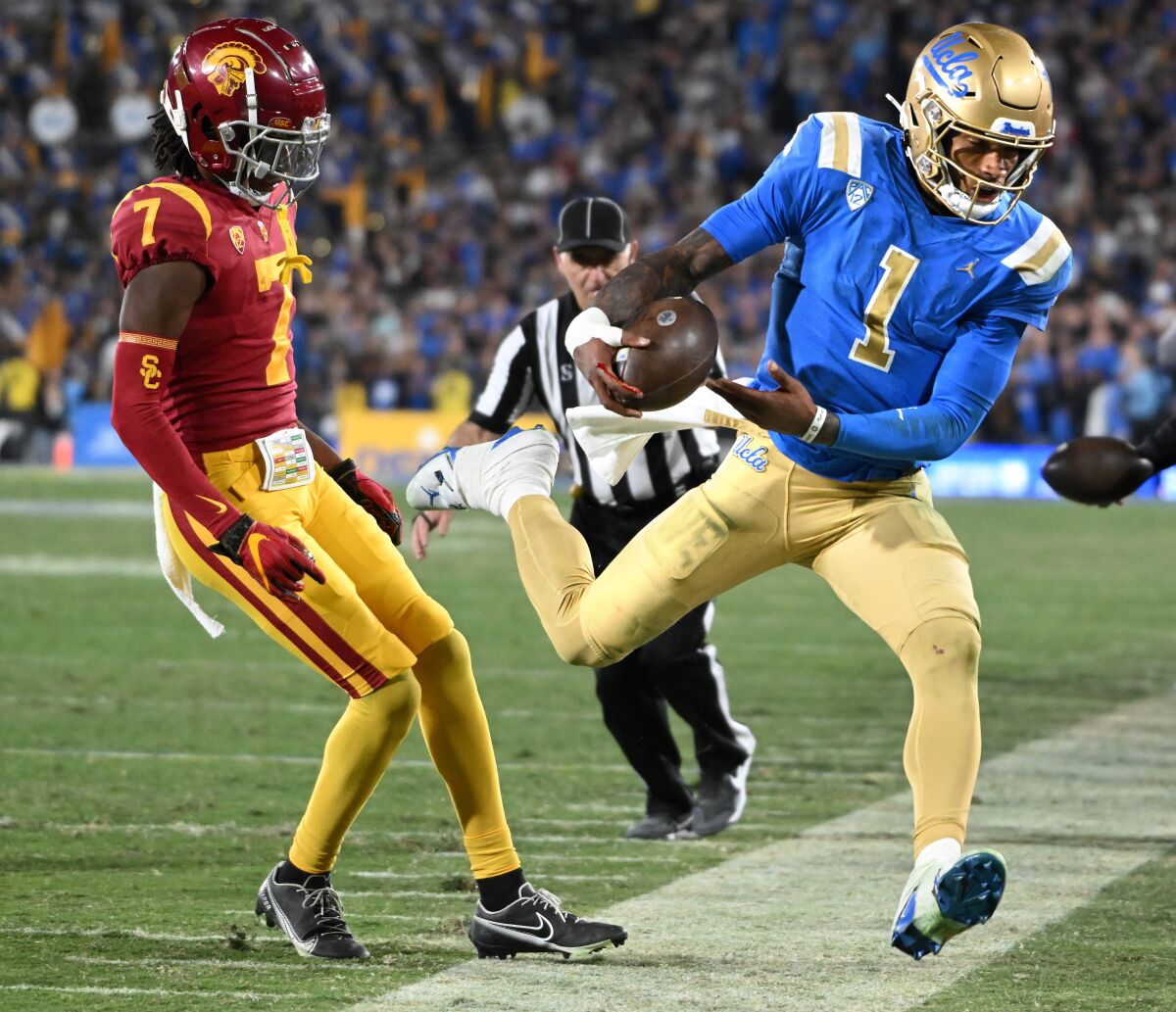 USC's Calen Bullock forces scrambling UCLA quarterback Dorian Thompson-Robinson out of bounds.