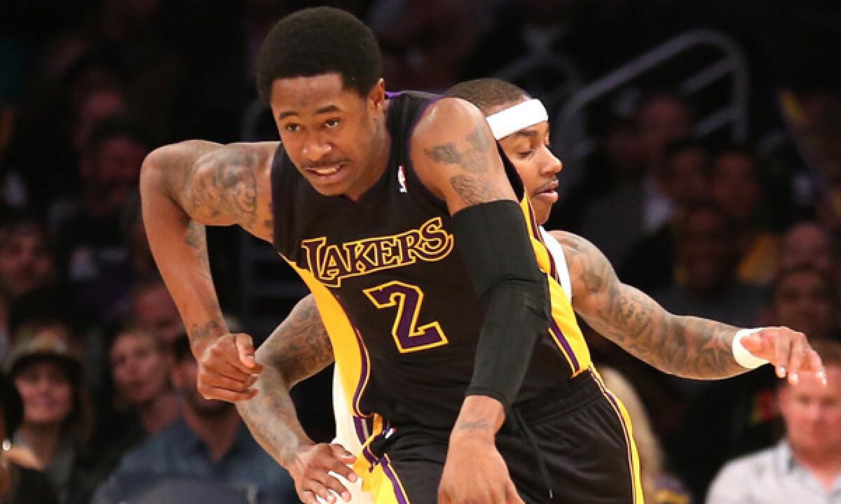 Lakers guard MarShon Brooks, front, starts a fast break ahead of Sacramento Kings point guard Isaiah Thomas during Friday's win. Brooks finished with 23 points in the game.
