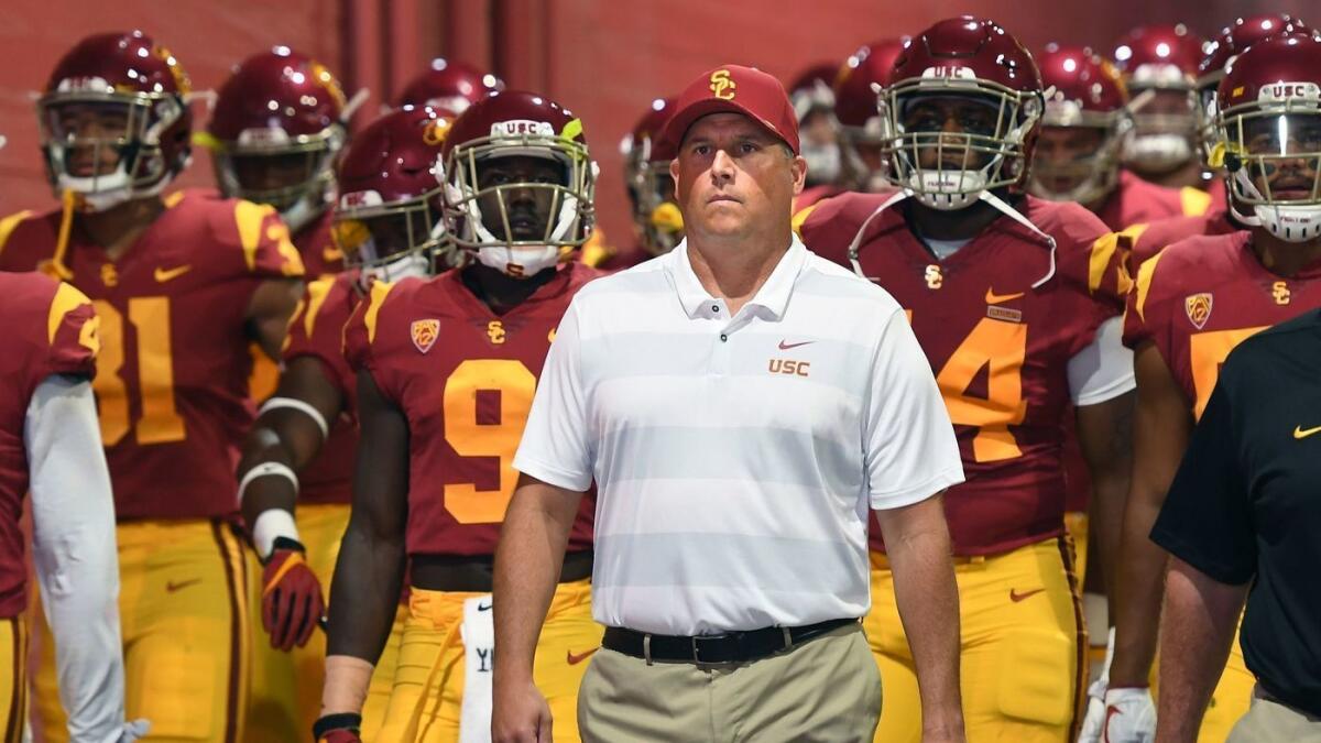 USC head coach Clay Helton leads his team on to the field at the Coliseum.