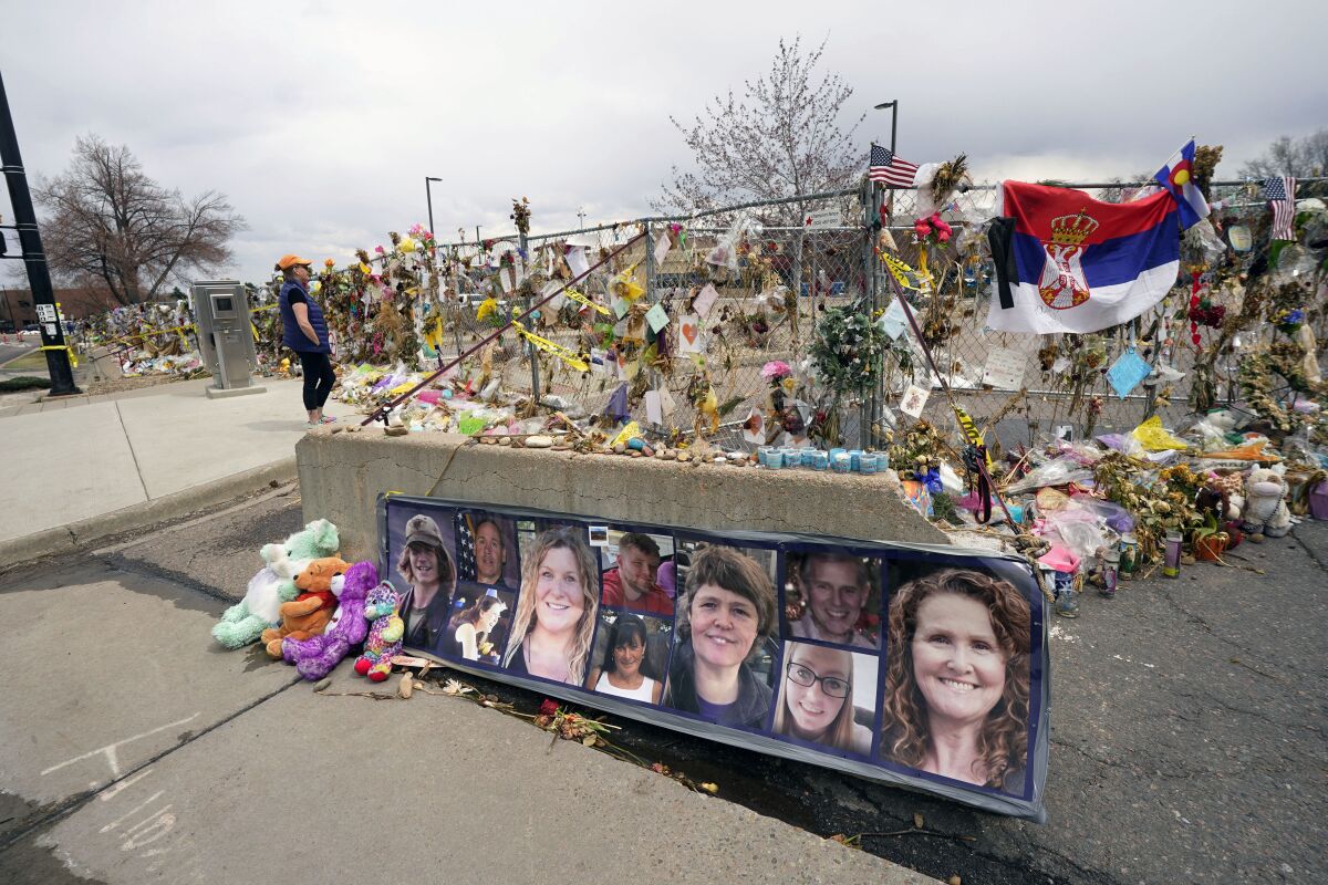 FILE - Tributes cover the temporary fence around the King Soopers grocery store in which 10 people died in a mass shooting in late March on Friday, April 23, 2021, in Boulder, Colo. A judge is scheduled to hold a hearing Friday, Jan. 27, 2023 to discuss whether a man charged with killing 10 people at a Colorado supermarket nearly two years ago is mentally competent to stand trial. (AP Photo/David Zalubowski, File)