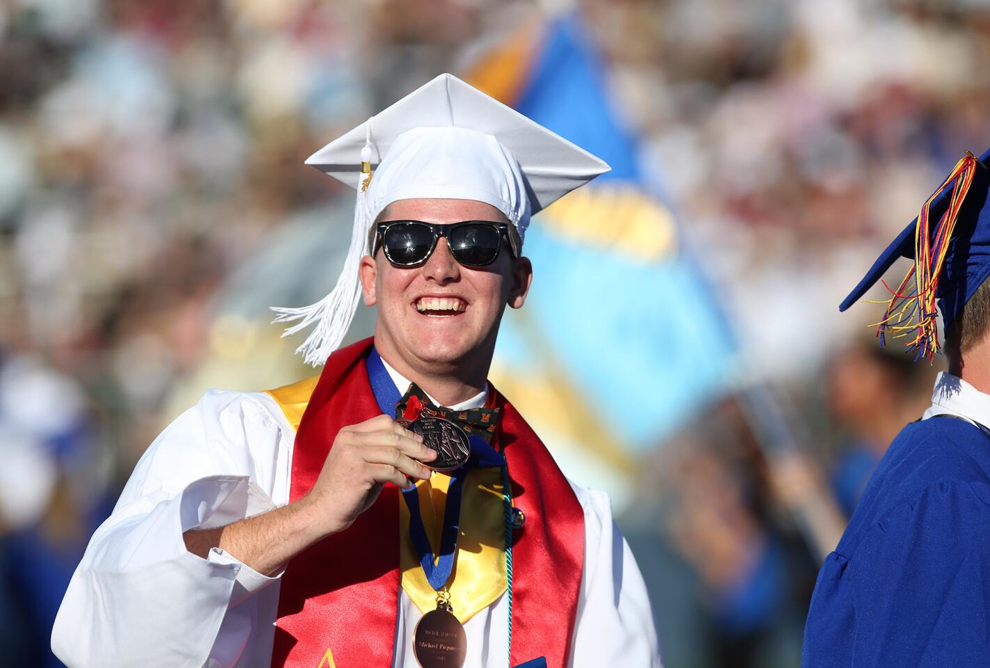 Graduate Michael Piepmeyer smiles to his family in the audience during the 2018 Fountain Valley High School commencement ceremony Wednesday at Orange Coast College in Costa Mesa.