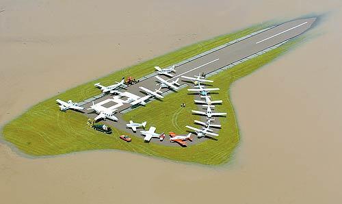 Small planes are clustered together after being towed to the only remaining dry land at Bloomsburg Airport in Pennsylvania. Floodwaters from the Susquehanna River continue to encroach on the airstrip. Although the rain has stopped, forecasters say more showers and thunderstorms could occur along the East Coast for the rest of the week.