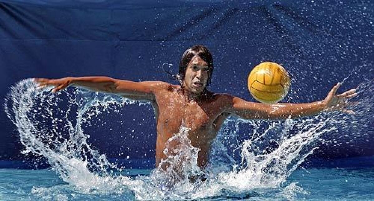 Members of the girls' and boys' water polo teams at Santa Ana's Valley High School take practice shots at teammate Jesus Chavez. To promote health and safety, the city's high schools are encouraging competitive swimming and water polo among Latinos, among the sports most underrepresented groups.