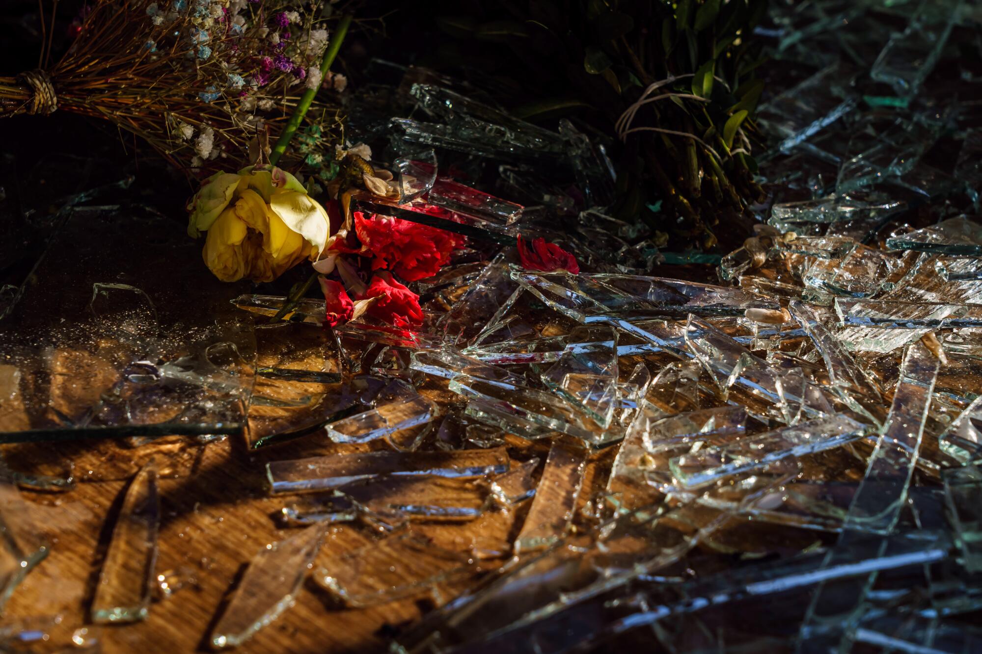 Shards of glass and flowers cover the ground inside a floral shop damaged by a Russian missile strike in Kyiv, Ukraine